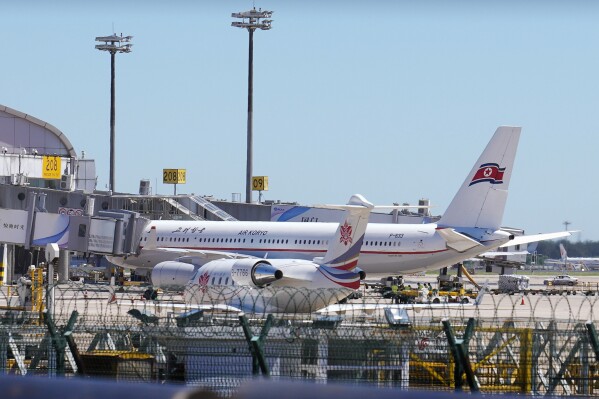 Ground crew work near an Air Koryo commercial plane on the tarmac at the Beijing Capital International Airport in Beijing, Tuesday, Aug. 22, 2023. A North Korean commercial flight has landed in Beijing amid signs that Pyongyang is opening borders again after almost three years of COVID-19 restrictions. (AP Photo/Andy Wong)