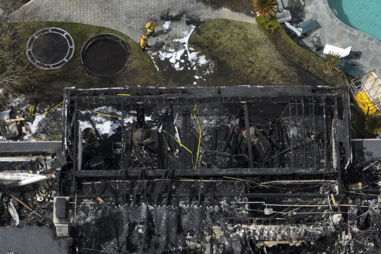 An aerial view shows a fire-damaged property, which appears to belong to Cara Delevingne, Friday, March 15, 2024, in the Studio City section of Los Angeles. (AP Photo/Jae C. Hong)