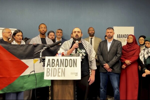 In this image taken from video, Muslim community leaders from several swing states pledge to withdraw support for U.S. President Joe Biden on Saturday, Dec. 2, 2023, at a conference in Dearborn, Mich., citing his refusal to call for a cease-fire in Gaza. (#AbandonBiden via AP)