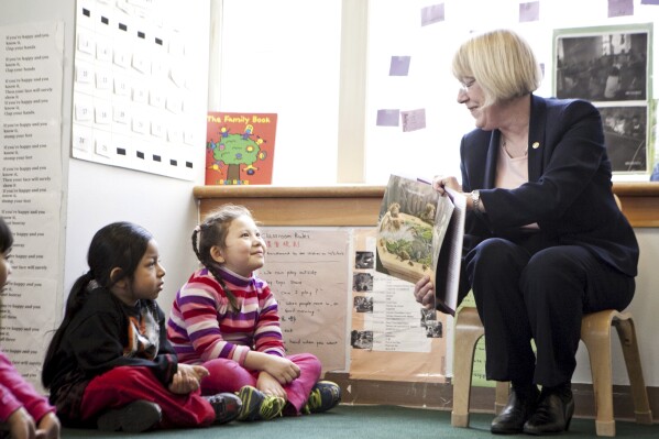 FILE - Senator Patty Murray, D-Wash., reads her favorite children's book, "King Bidgood's in the Bathtub," to preschoolers, including Diego Bicente, 4, left, and Anh Tang, 4, at the Denise Louie Education Center in the International District neighborhood of Seattle, March 25, 2013. Democrats in Congress are pushing for a new round of money to keep the nation’s child care industry afloat, saying thousands of programs are at risk of closing when federal pandemic relief runs out this month. (Bettina Hansen/The Seattle Times via AP, File)
