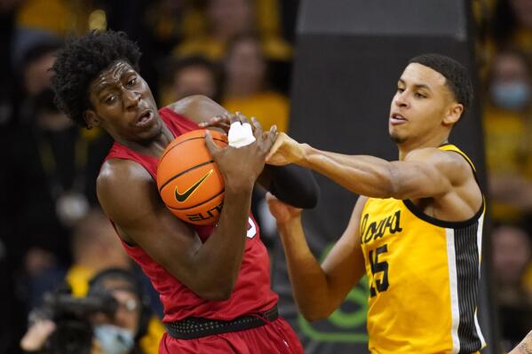 Nebraska center Eduardo Andre, left, fights for a rebound with Iowa forward Keegan Murray (15) during the second half of an NCAA college basketball game, Sunday, Feb. 13, 2022, in Iowa City, Iowa. (AP Photo/Charlie Neibergall)