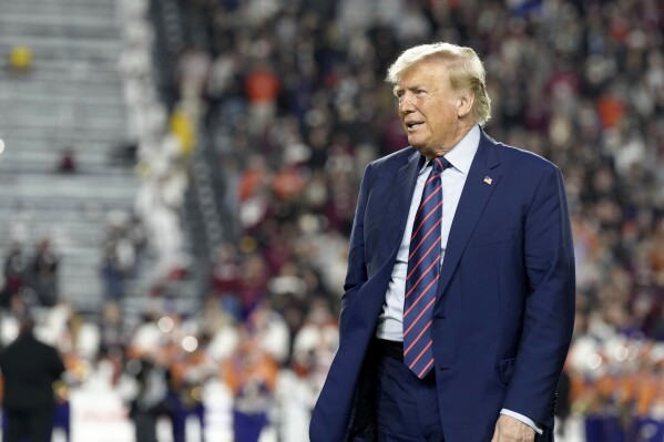 Republican presidential candidate and former President Donald Trump stands on the field during halftime in an NCAA college football game between the University of South Carolina and Clemson Saturday, Nov. 25, 2023, in Columbia, S.C. (AP Photo/Meg Kinnard)