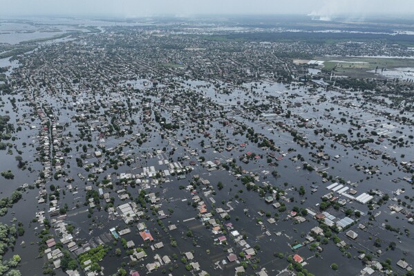 FILE - Houses are seen underwater in the flooded town of Oleshky, Ukraine, June 10, 2023. An AP investigation has found that Russian occupation authorities vastly and deliberately undercounted the dead in one of the most devastating chapters of the 22-month war in Ukraine - the flooding that followed the catastrophic explosion that destroyed the Kakhovka Dam in the southern Kherson region. (AP Photo/Evgeniy Maloletka, File)