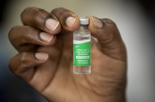FILE—In this Friday, March 5, 2021 file photo, a nurse holds a vial of AstraZeneca COVID-19 vaccine manufactured by the Serum Institute of India and provided through the global COVAX initiative, at Kenyatta National Hospital in Nairobi, Kenya. Kenya has ordered an immediate suspension on private importations of vaccines, citing fears that it  may lead to counterfeit inoculations getting into the country. The National Emergency Response Committee said the move is meant to ensure transparency and accountability in the process of vaccinations. (AP Photo/Ben Curtis, FIle)