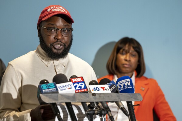 Darius McLean and Celena Morrison-McLean, right, hold a news conference on Thursday, March 7, 2024 in Philadelphia. Celena Morrison-McLean, a Philadelphia city official was arrested over the weekend during a traffic stop and started recording the incident because she feared for her husband's life as a trooper handcuffed him on a rainy elevated highway. (Tom Gralish/The Philadelphia Inquirer via AP)