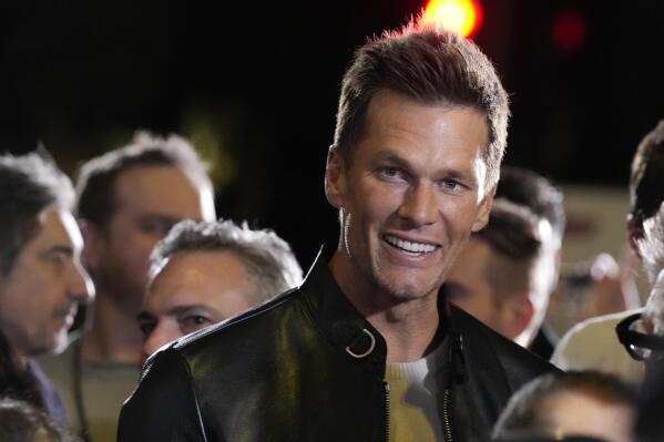 NFL quarterback Tom Brady, a cast member and producer of "80 for Brady," looks down the carpet at the premiere of the film, Tuesday, Jan. 31, 2023, at the Regency Village Theatre in Los Angeles. (AP Photo/Chris Pizzello)