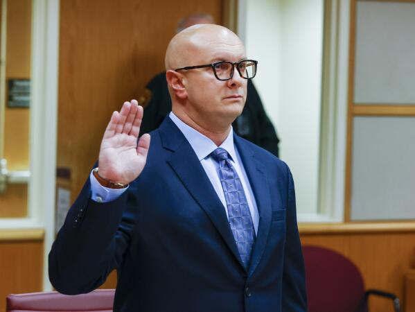 William Braddock raises his hand to take an oath during a hearing Tuesday, June 22, 2021, in Clearwater, Fla. Anna Paulina Luna, who plans to run for Florida's District 13 seat after losing a race for the slot in 2020 to Democratic U.S. Rep. Charlie Crist, contends in court documents that GOP challenger William Braddock is stalking her and wants her dead. Luna has filed a petition for a permanent restraining order.  Braddock denies the claims and wants to see any evidence against him. (Chris Urso/Tampa Bay Times via AP)