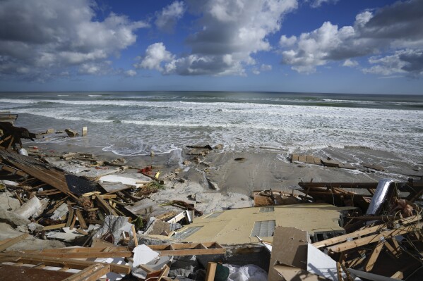 FILE - A piece of wall is seen amid the wreckage of Nina Lavigna's beachfront home, after half of her house collapsed following Hurricane Nicole, Nov. 12, 2022, in Wilbur-By-The-Sea, Fla. Record hot ocean temperatures and a tardy El Nino are doubling the chances of a nasty Atlantic hurricane season this summer and fall, the National Oceanic and Atmospheric Administration said Thursday, Aug. 10, 2023. (AP Photo/Rebecca Blackwell, File)