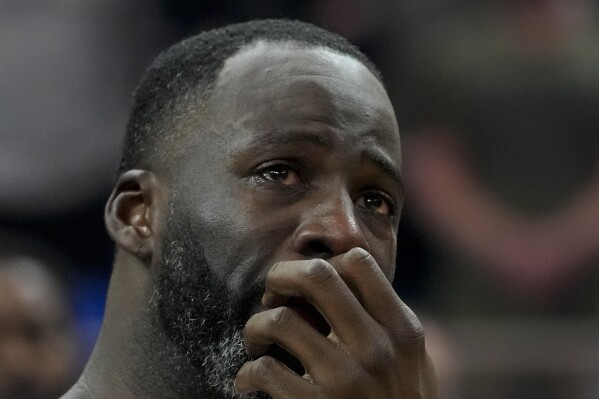 Golden State Warriors forward Draymond Green cries after watching a video tribute for late assistant coach Dejan Milojevic, who died Jan. 17 after suffering a heart attack, before an NBA basketball game against the Atlanta Hawks, Wednesday, Jan. 24, 2024, in San Francisco. (AP Photo/Godofredo A. Vásquez)