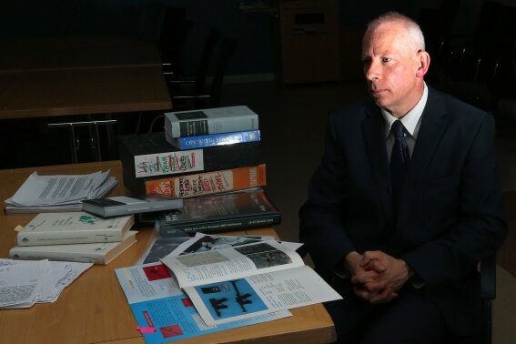 
              Michael Crowley of Bradford University fellow sits next to research materials during an interview in Bradford, England on Thursday, Sept. 22, 2016. As the project coordinator at the university's Non-Lethal Weapons Research Project, he says two state-owned companies in China have marketed "narcosis" dart guns. He said the ammunition "might very well be fentanyl or an analog of fentanyl," adding that in the 1990s, the U.S. explored similar guns loaded with a form of the opoiod. (AP Photo/Scott Heppell)
            
