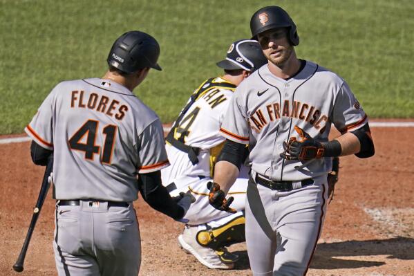 San Francisco Giants' Austin Slater, right, celebrates with Wilmer Flores (41) after hitting a solo home run off Pittsburgh Pirates starting pitcher Jose Quintana during the fifth inning of a baseball game in Pittsburgh, Saturday, June 18, 2022. (AP Photo/Gene J. Puskar)