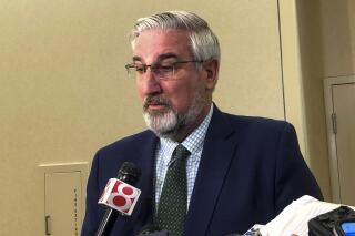 Indiana Gov. Eric Holcomb speaks with reporters after an Indiana Black Expo event at the Indiana Convention Center in Indianapolis, Tuesday, July 12, 2022. Holcomb sidestepped taking a stance on how far the Republican-dominated Legislature should go in further restricting abortions in the state when lawmakers begin a special session on July 25. (AP Photo/Tom Davies)
