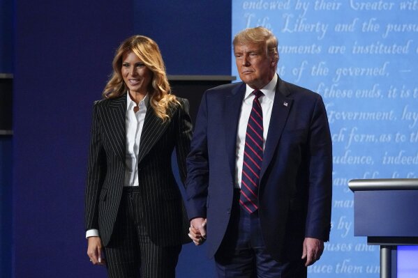 President Donald Trump and first lady Melania Trump hold hands on stage after the first presidential debate at Case Western University and Cleveland Clinic, in Cleveland, Ohio, Sept. 29, 2020. (AP Photo/Julio Cortez, File)