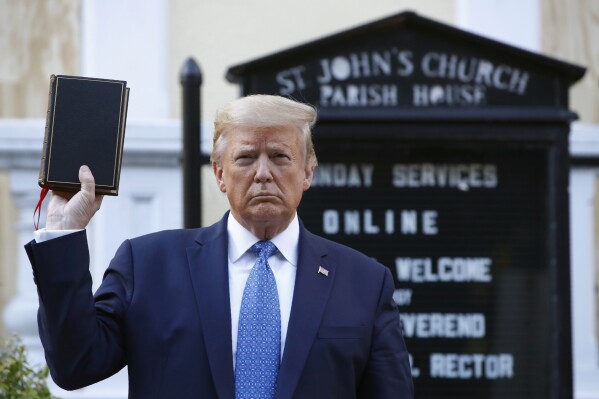 FILE - President Donald Trump holds a Bible as he visits outside St. John's Church across Lafayette Park from the White House, June 1, 2020, in Washington. Trump is now selling Bibles as he runs to return to the White House. The presumptive Republican nominee released a video on his Truth Social platform Tuesday urging his supporters to purchase the “God Bless The USA Bible." (AP Photo/Patrick Semansky, File)