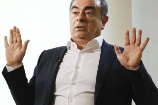 Former Nissan Chairman Carlos Ghosn speaks to Japanese media during an interview in Beirut, Lebanon, Friday, Jan. 10, 2020. A lawyer for Carlos Ghosn, Nissan's former chairman who skipped bail in Japan and fled to Lebanon, on Friday slammed a gaffe by the Japanese justice minister who said that Ghosn should “prove" his innocence. Ghosn, who was awaiting trial on financial misconduct charges, fled Tokyo and appeared in Beirut Dec. 30. (Meika Fujio/Kyodo News via AP)