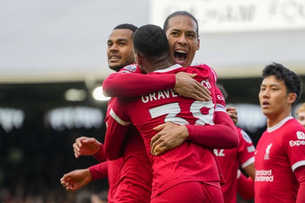 Liverpool's Ryan Gravenberch, front, celebrates with Liverpool's Virgil van Dijk after scoring his side's second goal during the English Premier League soccer match between Fulham and Liverpool at Craven Cottage stadium in London, Sunday, April 21, 2024. (AP Photo/Kirsty Wigglesworth)
