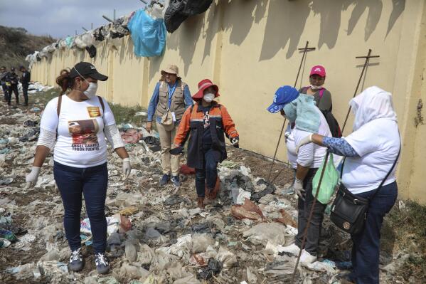 FILE - Members of the Solecito Collective who are seeking their missing loved ones look for signs of clandestine graves inside a municipal dump in the port city of Veracruz, Mexico, March 11, 2019. Mexican activists filed a criminal complaint Wednesday, Oct. 19, 2022, at the International Court of Justice at The Hague, arguing authorities cooperated with or allowed drug cartels to abduct people who were never seen again. The case involves hundreds of people who disappeared in Mexico’s Gulf coast state of Veracruz between 2010 and 2016. (AP Photo/Felix Marquez, File)