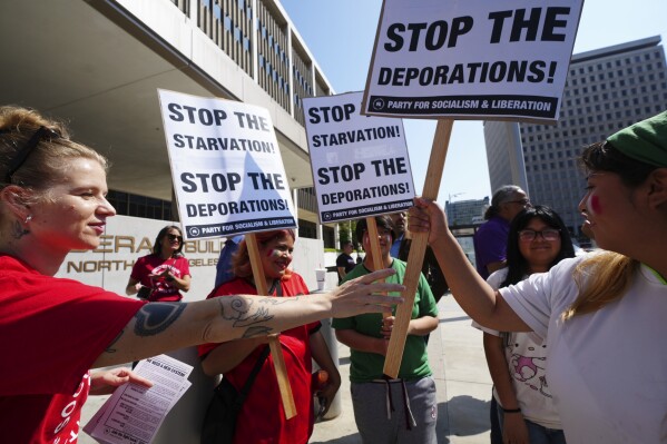 Community organizers gather outside the Federal Building after federal immigration authorities conducted an operation Friday, June 6, 2025, in Los Angeles. (AP Photo/Damian Dovarganes)