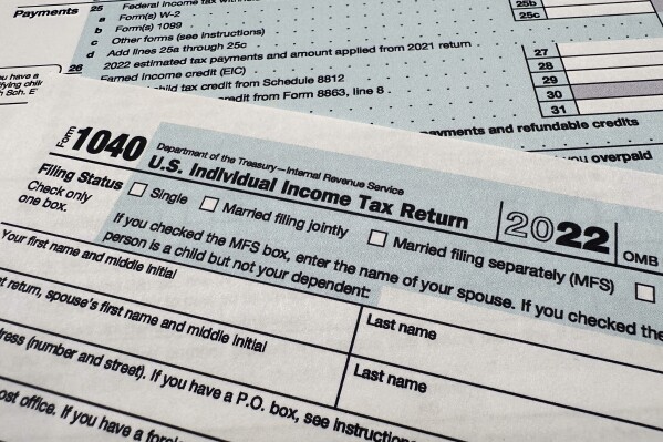FILE - The Internal Revenue Service 1040 tax form for 2022 is seen on April 17, 2023. The IRS said Friday, April 26, 2024, more than 140,000 taxpayers filed their taxes through its new direct file pilot program. It says the program's users claimed more than $90 million in refunds, saving roughly $5.6 million in fees they would have spent with commercial tax preparation companies. (Ǻ Photo/Jon Elswick, File)