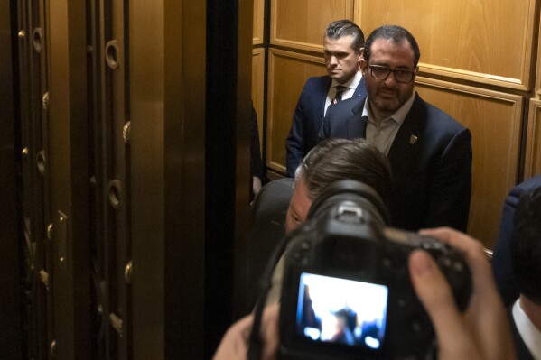 Pete Hegseth, President-elect Donald Trump's pick for Secretary of Defense, in back, stands in an elevator after meeting with senators on Capitol Hill, Thursday, Nov. 21, 2024, in Washington. (AP Photo/Mark Schiefelbein)