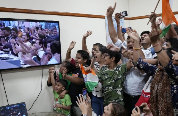 Schoolchildren cheer as they watch the successful landing of Chandrayaan-3, or “moon craft” in Sanskrit, at the Nehru Planetarium in New Delhi, India, Wednesday, Aug. 23, 2023. (AP Photo/Manish Swarup)