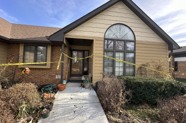 FILE - The front door of the rectory where the Rev. Stephen Gutgsell's was fatally stabbed on Dec. 10, 2023, in tiny Fort Calhoun, Neb., remained wrapped in crime scene tape on Dec. 14. Prosecutors have decided not to seek the death penalty in the December killing of the Catholic priest inside his home, but they are pursuing execution in the brutal killing of a retiree during a break-in that happened in the same tiny Nebraska town four months earlier. (AP Photo/Josh Funk, File)