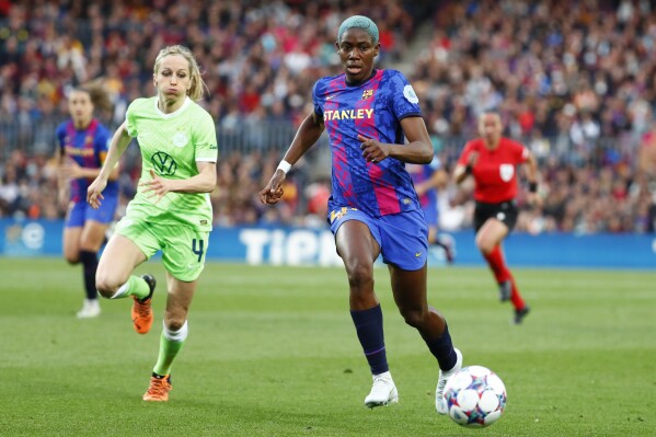 FILE - Wolfsburg's Kathrin Julia Hendrich, chases down Barcelona's Asisat Oshoala during the Women's Champions League semifinal, first leg, soccer match between Barcelona and Wolfsburg at Camp Nou stadium in Barcelona, Spain, Friday, April 22, 2022. National Women's Soccer League expansion team Bay FC has acquired Nigerian forward Asisat Oshoala via a transfer from Barcelona. Oshoala is also one of the top players in the history of Nigeria’s national team. (AP Photo/Joan Monfort, File)