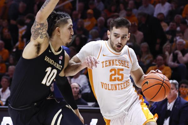 Tennessee guard Santiago Vescovi (25) drives against Vanderbilt forward Myles Stute (10) during the first half of an NCAA college basketball game Saturday, Feb. 12, 2022, in Knoxville, Tenn. (AP Photo/Wade Payne)