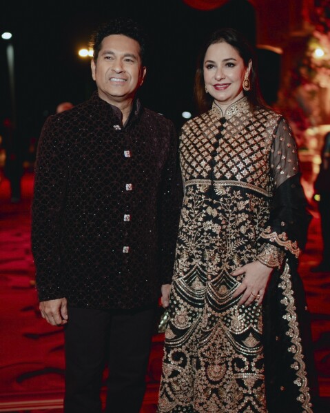 This photograph released by the Reliance group shows Indian cricketer Sachin Tendulkar posing for a photograph with his wife Anjali at a pre-wedding bash of billionaire industrialist Mukesh Ambani's son Anant Ambani in Jamnagar, India, Saturday, Mar. 02, 2024. (Reliance group via AP)