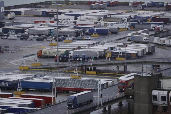 FILE - Lorries leave after disembarking a ferry as others wait to board on the morning after Brexit took place at the Port of Dover in Dover, England, Saturday, Feb. 1, 2020. Britain announced Thursday, April 28, 2022 that it is postponing until the end of 2023 some checks on imports from the European Union that are required under post-Brexit trade rules, citing economic disruption caused by the war in Ukraine. (AP Photo/Matt Dunham, File)