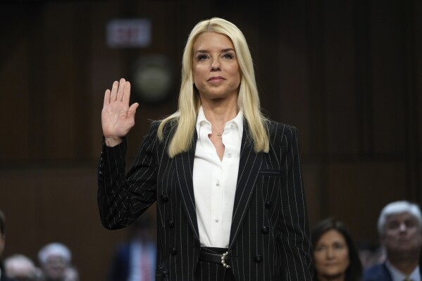 Pam Bondi, President-elect Donald Trump's choice to lead the Justice Department as attorney general, is sworn in before the Senate Judiciary Committee for her confirmation hearing, at the Capitol in Washington, Wednesday, Jan. 15, 2025. (AP Photo/Ben Curtis)