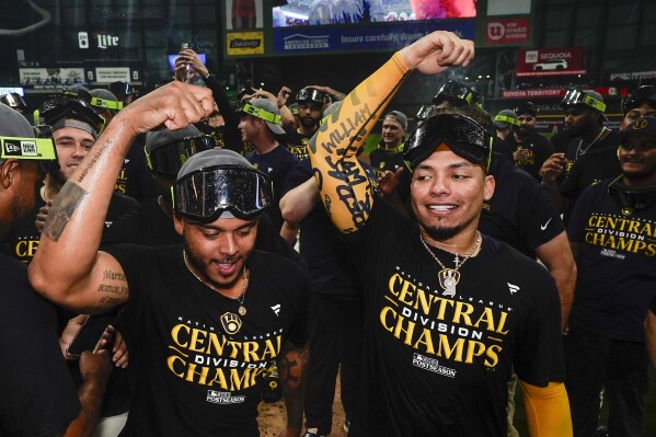 Milwaukee Brewers' Freddy Peralta and William Contreras celebrate after clinching the National League Central Division after a baseball game against the St. Louis Cardinals Tuesday, Sept. 26, 2023, in Milwaukee. (AP Photo/Morry Gash)