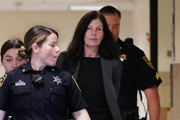 Former Pennsylvania Attorney General Kathleen Kane, center, is led to court as she arrives for a hearing on an alleged probation violation, at the Montgomery County Courthouse in Norristown, Pa., Monday, May 23, 2022. Pennsylvania's former top law enforcement officer, who served jail time for leaking secret investigative files and lying about it, faces the prospect of more time behind bars after she was arrested for drunken driving in March. (AP Photo/Matt Rourke)