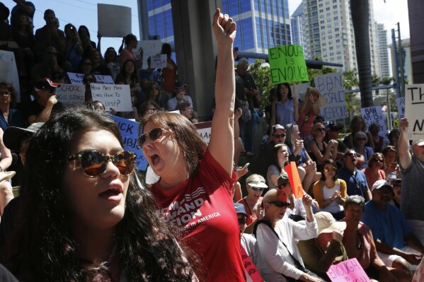 
              Helena Moreno, center, yells during a protest against guns on the steps of the Broward County Federal courthouse in Fort Lauderdale, Fla., on Saturday, Feb. 17, 2018. Nikolas Cruz, a former student, is charged with killing 17 people at Marjory Stoneman Douglas High School in Parkland, Fla., on Wednesday. (AP Photo/Brynn Anderson)
            