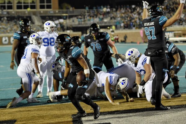 Coastal Carolina's Reese White, center, scores a touchdown during the first half of an NCAA college football game against BYU Saturday, Dec. 5, 2020, in Conway, S.C. (AP Photo/Richard Shiro)