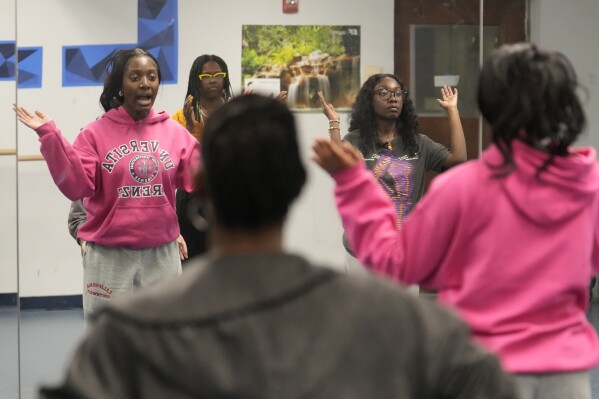 *Hillary Amofa, reflected right, practices in a mirror with members of the Lincoln Park High School step team after school Friday, March 8, 2024, in Chicago. When she started writing her college essay, Amofa told the story she thought admissions offices wanted to hear. She wrote about being the daughter of immigrants from Ghana, about growing up in a small apartment in Chicago. She described hardship and struggle. Then she deleted it all. "I would just find myself kind of trauma-dumping," said the 18 year-old senior, "And I'm just like, this doesn't really say anything about me as a person." (AP Photo/Charles Rex Arbogast)