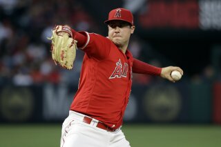 FILE - In this June 29, 2019, file photo, Los Angeles Angels starting pitcher Tyler Skaggs throws to the Oakland Athletics during a baseball game in Anaheim, Calif. Talks to add testing for opioids began following the death of Skaggs, who was found dead in his hotel room in the Dallas area July 1 before the start of a series against the Texas. Major League Baseball will start testing for opioids and cocaine, but only players who do not cooperate with their treatment plans will be subject to discipline, as part of changes announced Thursday, Dec. 12, 2019, to the joint drug agreement between MLB and the players' association. (AP Photo/Marcio Jose Sanchez, File)