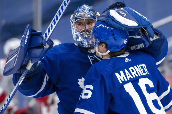 Toronto Maple Leafs goaltender Petr Mrazek (35) and right wing Mitchell Marner (16) celebrate after defeating the Carolina Hurricanes in overtime of an NHL hockey game in Toronto, Monday, Feb. 7, 2022. (Frank Gunn/The Canadian Press via AP)