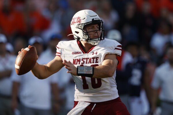 New Mexico State quarterback Diego Pavia throws a pass during the first half of an NCAA college football game against Auburn Saturday, Nov. 18, 2023, in Auburn, Ala. (AP Photo/Butch Dill)