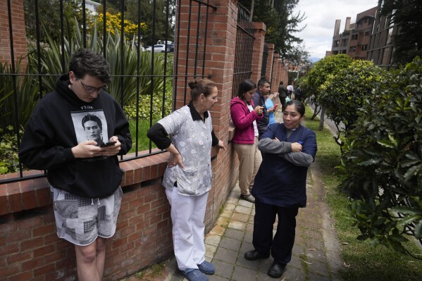 Residents gather outside their homes after a quake was felt in Bogota, Colombia, Thursday, Aug. 17, 2023. A magnitude 6.3 earthquake shook Colombia's capital and other major cities on Thursday, according to reports by United States Geological service. USGS reported a second 5.7 magnitude quake shortly after the first. (AP Photo/Ricardo Mazalan)