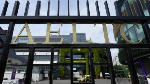 Through the gates at the All England Lawn Tennis and Croquet Club (AELTC), preparations are made ahead of the Wimbledon tennis championships in London, Monday, June 26, 2023. The Wimbledon tennis championships start on Monday July 3 and run for two weeks. (AP Photo/Kirsty Wigglesworth)