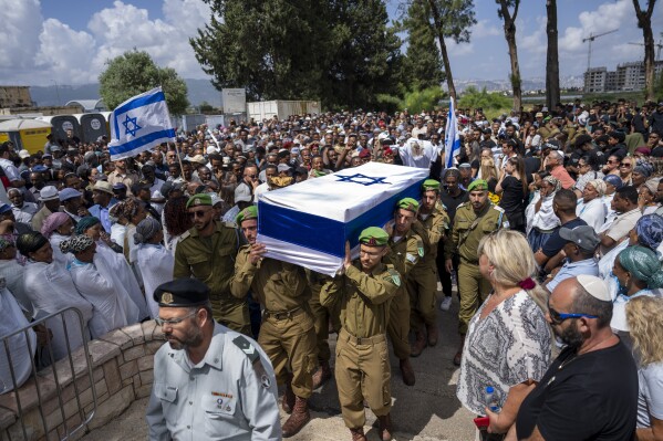 Israeli soldiers carry the casket of Sergeant Yosef Dassa during his funeral in Kiryat Ata, Israel, Sunday, May 12, 2024. Dassa ,19, was killed during Israel's ground operation in the Gaza Strip, where the Israeli army has been battling Palestinian militants in the war ignited by Hamas' Oct. 7 attack into Israel. (AP Photo/Ariel Schalit)
