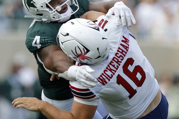 Michigan State's Jacoby Windmon, left, hits Richmond quarterback Kyle Wikersham after he releases the ball during the first half of an NCAA college football game, Saturday, Sept. 9, 2023, in East Lansing, Mich. (AP Photo/Al Goldis)