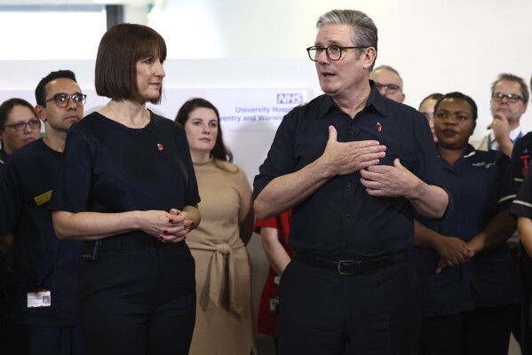 Britain's Prime Minister Keir Starmer and Chancellor Rachel Reeves speak with members of staff, during a visit to University Hospital Coventry and Warwickshire, in Coventry, England, Thursday, Oct. 31, 2024. (AP Photo/Darren Staples, pool)