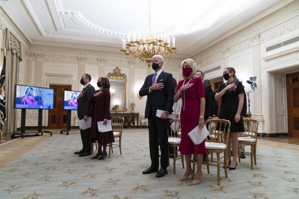 Doug Emhoff, left, Vice President Kamala Harris, President Joe Biden, and first lady Jill Biden, stand during a performance of the national anthem during a virtual Presidential Inaugural Prayer Service, in the State Dinning Room of the White House, Thursday, Jan. 21, 2021, in Washington. (AP Photo/Alex Brandon)