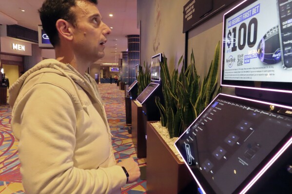 Matt Smircich, of Hamburg, N.J., makes sports bets at the Hard Rock casino in Atlantic City, N.J., Friday, Feb. 2, 2024. On Tuesday, Feb. 6, 2024, the American Gaming Association estimated that a record 68 million Americans would wager a total of $23.1 billion on this year's Super Bowl, legally or otherwise. (APPhoto/Wayne Parry)