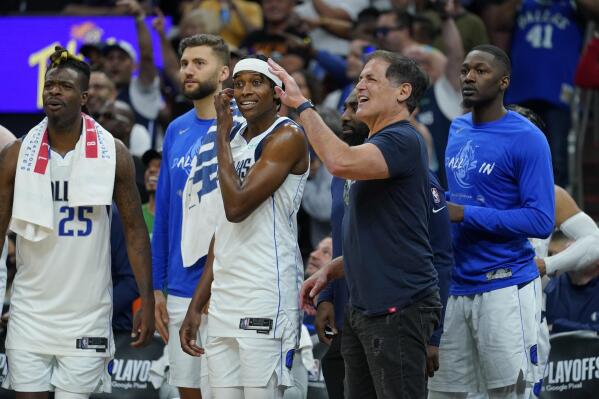 Dallas Mavericks owner Mark Cuban and players celebrate during the second half of Game 7 of an NBA basketball Western Conference playoff semifinal against the Phoenix Suns, Sunday, May 15, 2022, in Phoenix. The Mavericks defeated the Suns 123-90. (AP Photo/Matt York)