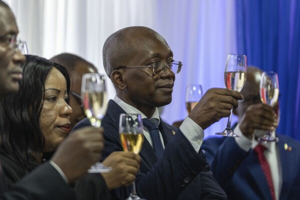 Michel Patrick Boisvert, who was named interim prime minister by the cabinet of outgoing Prime Minister Ariel Henry, toasts during the swearing-in ceremony of the transitional council tasked with selecting Haiti's new prime minister and cabinet, in Port-au-Prince, Haiti, Thursday, April 25, 2024. Boisvert was previously the economy and finance minister. (AP Photo/Ramon Espinosa)