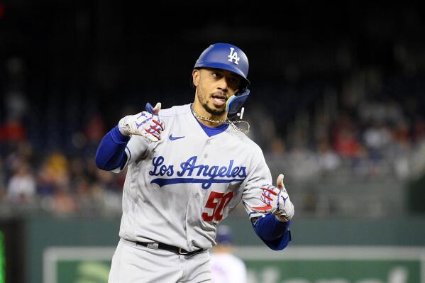 Los Angeles Dodgers' Mookie Betts celebrates his home run as he rounds the bases during the fourth inning of a baseball game against the Washington Nationals, Tuesday, May 24, 2022, in Washington. (AP Photo/Nick Wass)