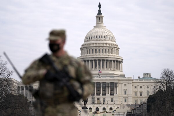 FILE - A member of the National Guard patrols the area outside of the U.S. Capitol at the Capitol in Washington, Wednesday, Feb. 10, 2021. The House passed a defense policy bill Thursday, Dec. 14, 2023, that authorizes the biggest pay raise for troops in more than two decades, overcoming objections from some conservatives concerned the measure did not do enough to restrict the Pentagon's diversity initiatives, abortion travel policy and gender-affirming health care for transgender service members. (AP Photo/Jose Luis Magana, File)